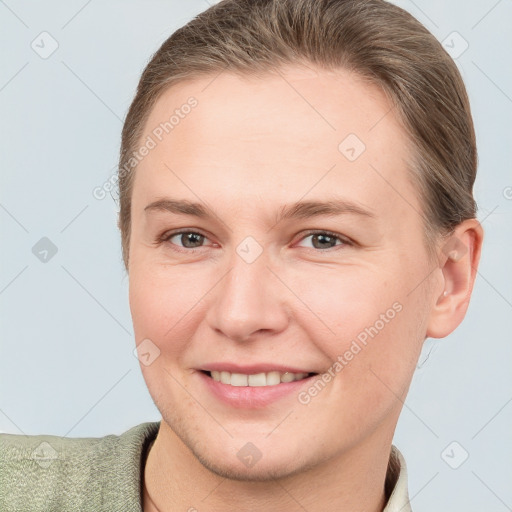 Joyful white young-adult female with short  brown hair and brown eyes