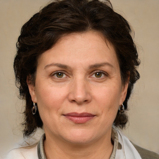 Joyful white adult female with medium  brown hair and green eyes