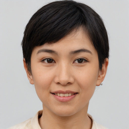 Joyful asian young-adult female with short  brown hair and brown eyes