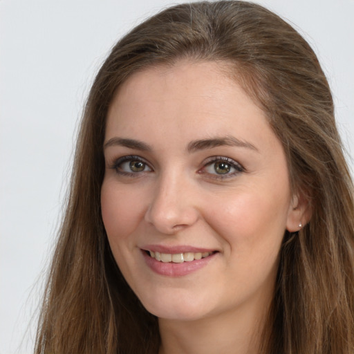 Joyful white young-adult female with long  brown hair and grey eyes