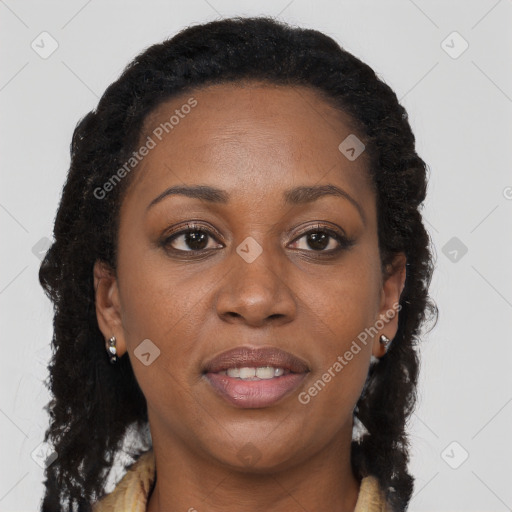 Joyful black young-adult female with long  brown hair and brown eyes