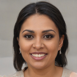 Joyful latino young-adult female with medium  brown hair and brown eyes