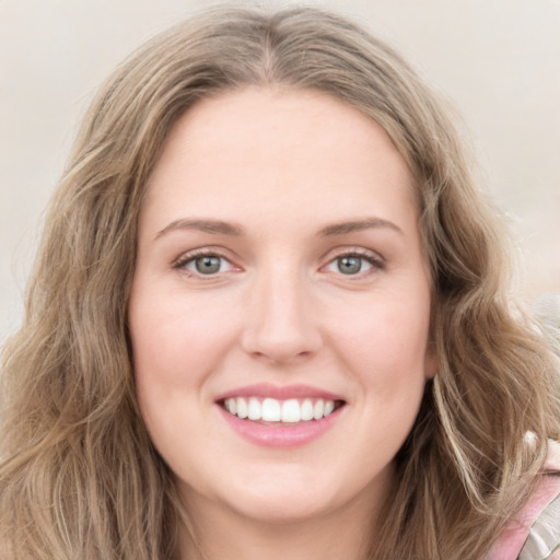 Joyful white young-adult female with long  brown hair and green eyes