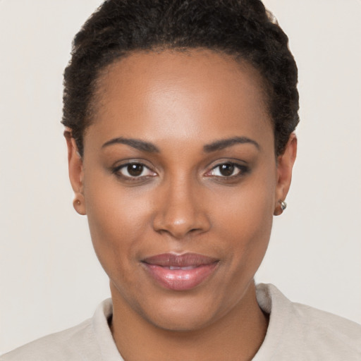 Joyful black young-adult female with short  brown hair and brown eyes