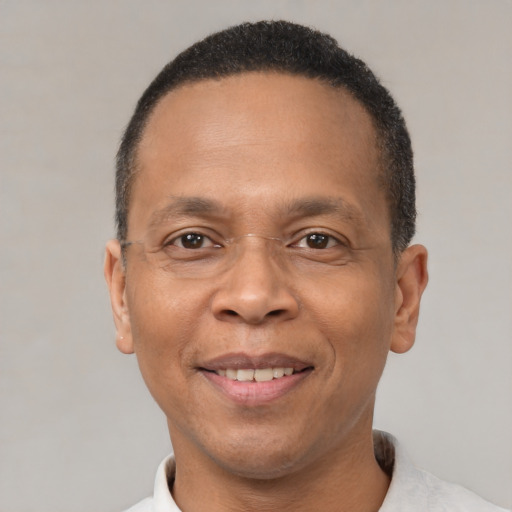 Joyful latino adult male with short  brown hair and brown eyes