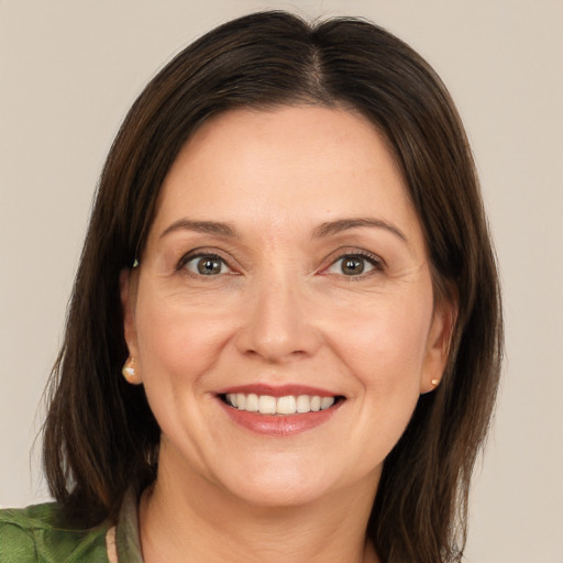 Joyful white adult female with medium  brown hair and brown eyes