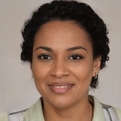 Joyful black young-adult female with medium  brown hair and brown eyes