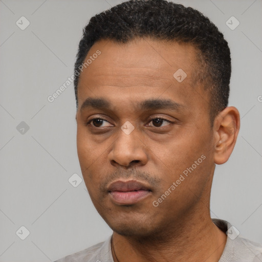 Neutral black young-adult male with short  black hair and brown eyes