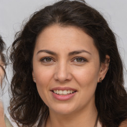 Joyful white adult female with long  brown hair and brown eyes