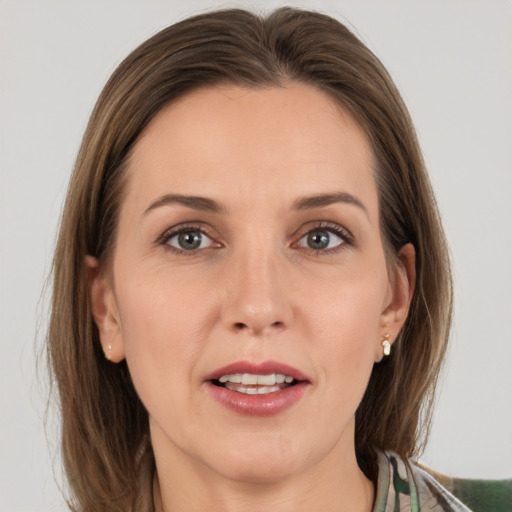 Joyful white young-adult female with medium  brown hair and grey eyes