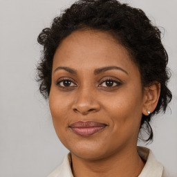 Joyful black adult female with medium  brown hair and brown eyes