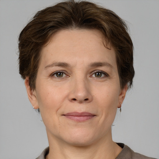 Joyful white adult female with short  brown hair and grey eyes