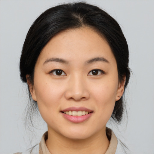 Joyful asian young-adult female with medium  black hair and brown eyes