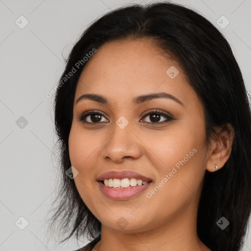 Joyful latino young-adult female with long  black hair and brown eyes