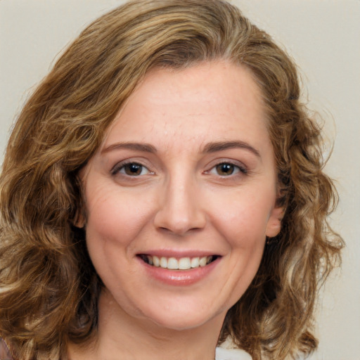 Joyful white young-adult female with medium  brown hair and green eyes