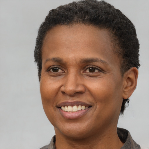 Joyful latino adult female with short  brown hair and brown eyes