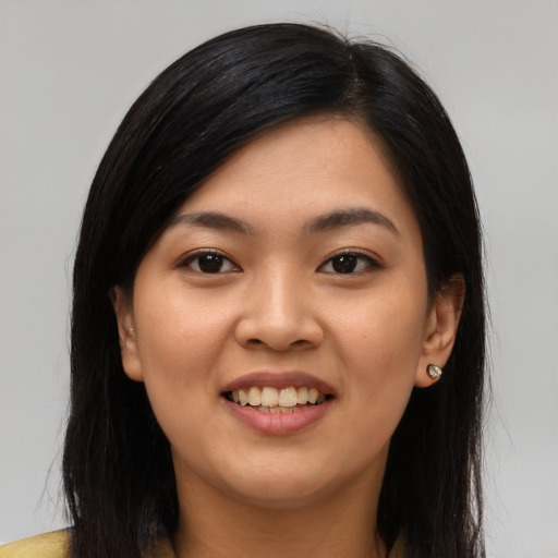 Joyful asian young-adult female with long  black hair and brown eyes