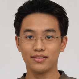 Joyful asian young-adult male with short  black hair and brown eyes