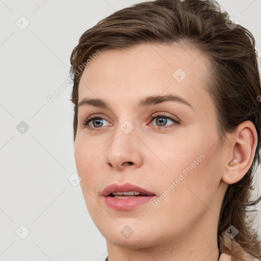 Joyful white young-adult female with long  brown hair and blue eyes