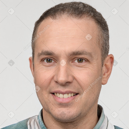 Joyful white adult male with short  brown hair and brown eyes