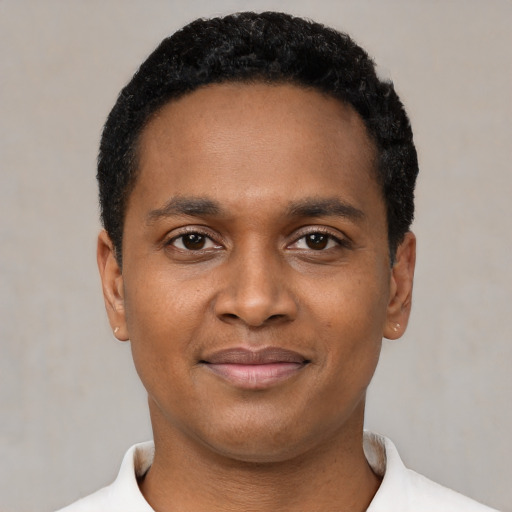 Joyful black young-adult male with short  black hair and brown eyes