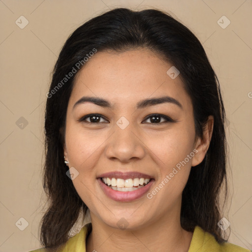 Joyful latino young-adult female with long  brown hair and brown eyes