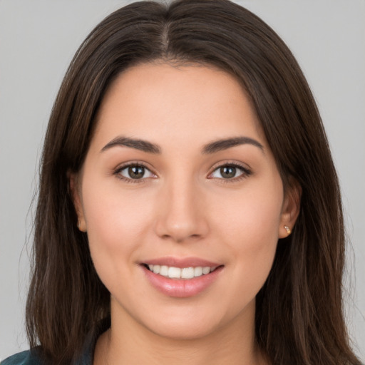 Joyful white young-adult female with long  brown hair and brown eyes