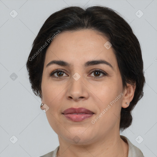 Joyful latino adult female with medium  brown hair and brown eyes