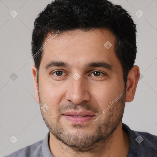 Joyful white young-adult male with short  black hair and brown eyes