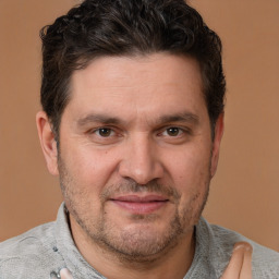 Joyful white adult male with short  brown hair and brown eyes