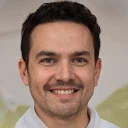 Joyful white adult male with short  brown hair and brown eyes