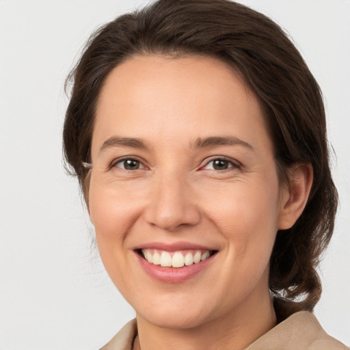 Joyful white young-adult female with medium  brown hair and brown eyes