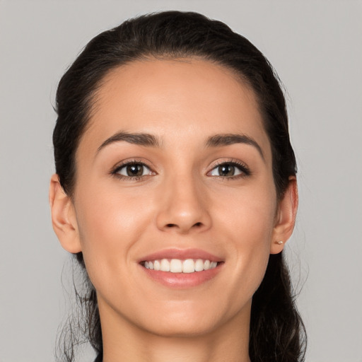 Joyful white young-adult female with long  brown hair and brown eyes