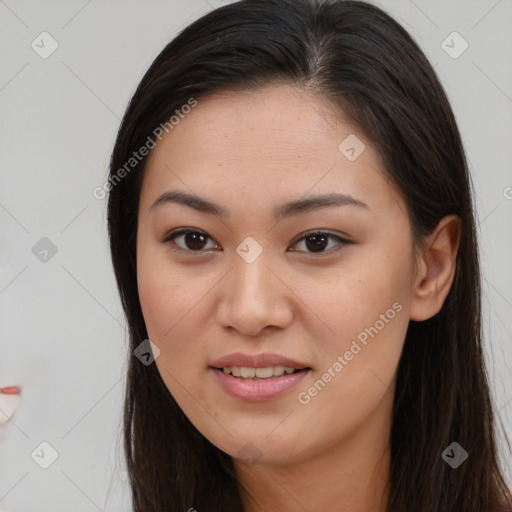 Joyful asian young-adult female with long  brown hair and brown eyes