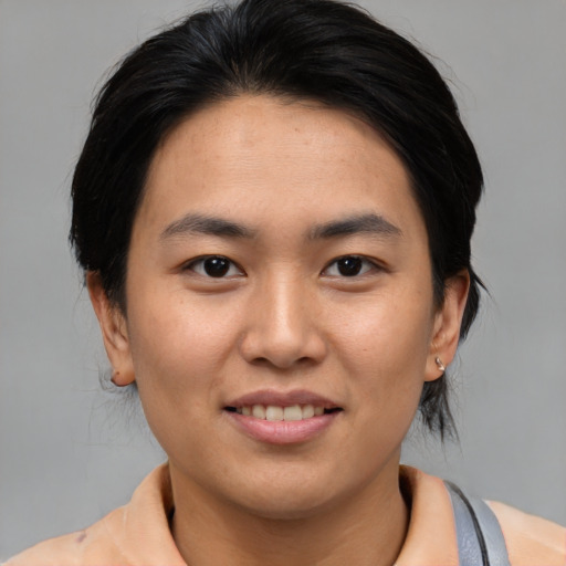 Joyful asian young-adult male with medium  brown hair and brown eyes