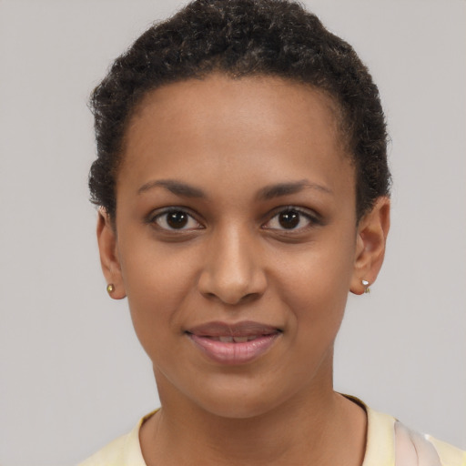 Joyful black young-adult female with short  brown hair and brown eyes