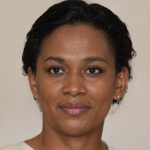 Joyful black adult female with short  brown hair and brown eyes