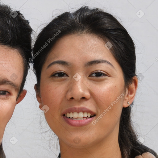 Joyful asian young-adult female with medium  brown hair and brown eyes