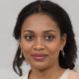 Joyful black young-adult female with medium  brown hair and brown eyes