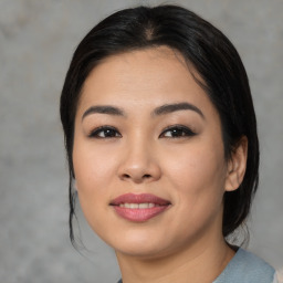 Joyful asian young-adult female with medium  black hair and brown eyes