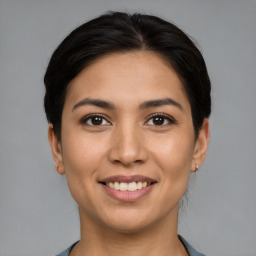 Joyful white young-adult female with medium  brown hair and brown eyes