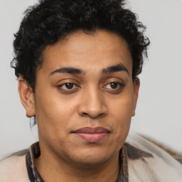 Joyful latino young-adult male with short  brown hair and brown eyes