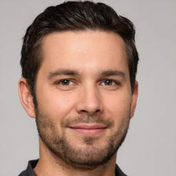 Joyful white young-adult male with short  brown hair and brown eyes