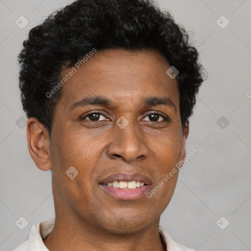 Joyful black young-adult male with short  brown hair and brown eyes