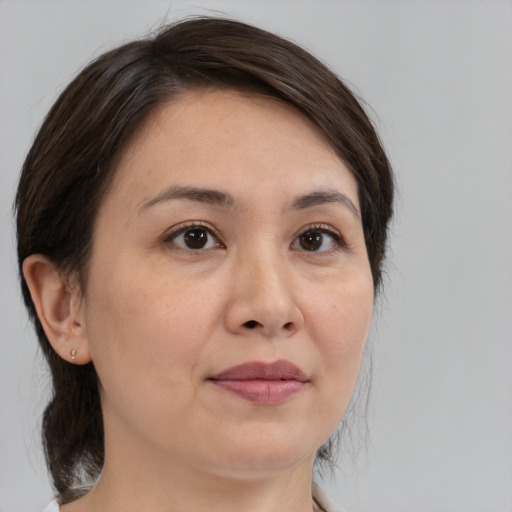 Joyful white young-adult female with medium  brown hair and brown eyes