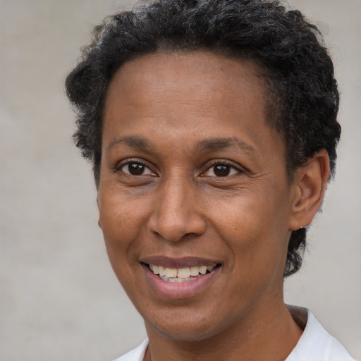 Joyful latino adult female with short  brown hair and brown eyes