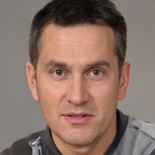 Joyful white adult male with short  brown hair and brown eyes