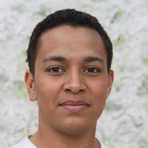 Joyful latino young-adult male with short  brown hair and brown eyes