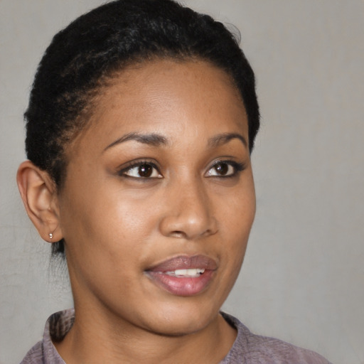 Joyful black young-adult female with short  brown hair and brown eyes