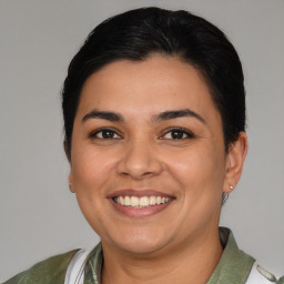 Joyful latino young-adult female with short  brown hair and brown eyes